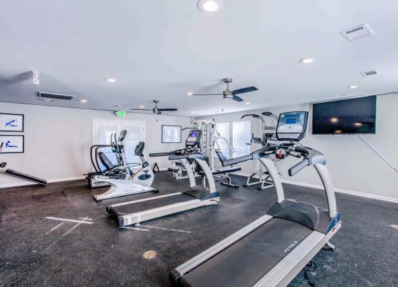 a gym with treadmills and other exercise equipment