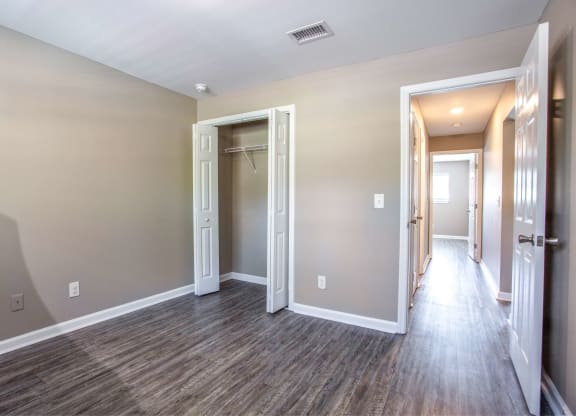 the living room and hallway of a new home with wood flooring