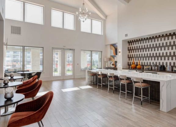 a large room with a bar and chairs