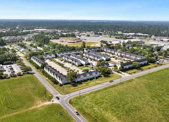 A bird's eye view of a residential area with houses and a road.