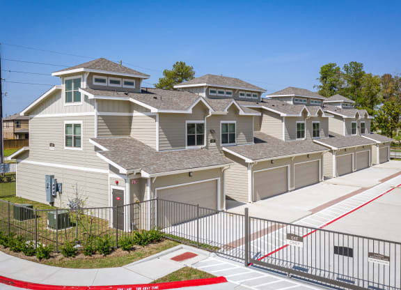 a row of houses in a neighborhood with a sidewalk and gate