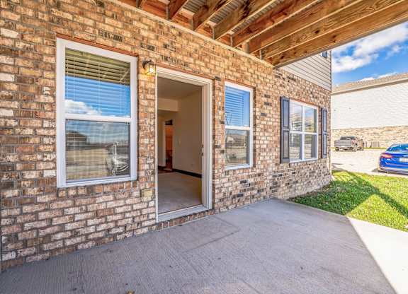 the entrance to a brick building with an open door