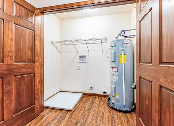 a room with a water heater and a shower in it