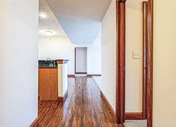 the view from the living room into the kitchen and dining room