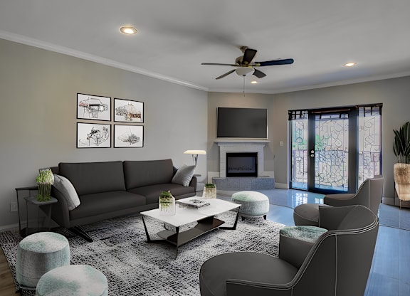 A modern living room with a grey sofa, a coffee table, and a ceiling fan.