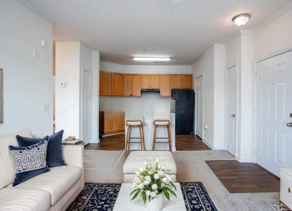 A living room with a white couch and a wooden cabinet.