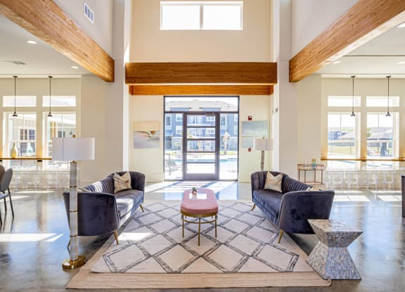 a living room with couches and a coffee table in front of a door