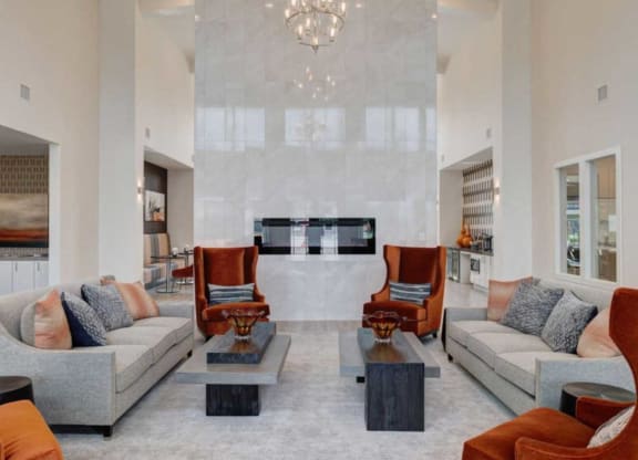 a living room with couches and chairs and a fireplace