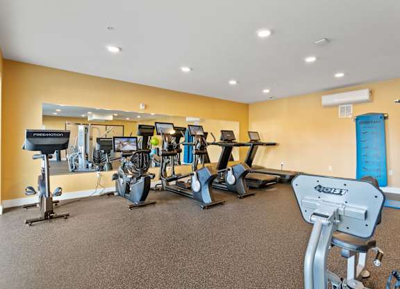 A gym with a variety of exercise equipment.