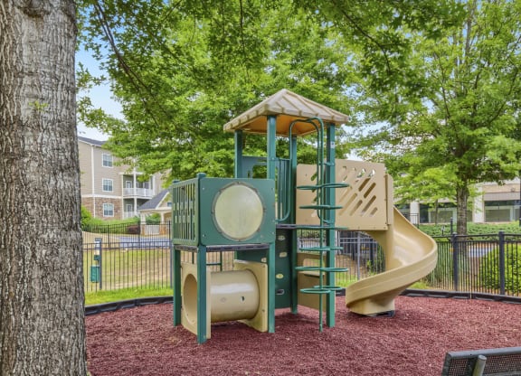 a playground with a jungle gym and a slide
