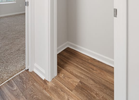 an empty bedroom with a closet with a mirrored closet door