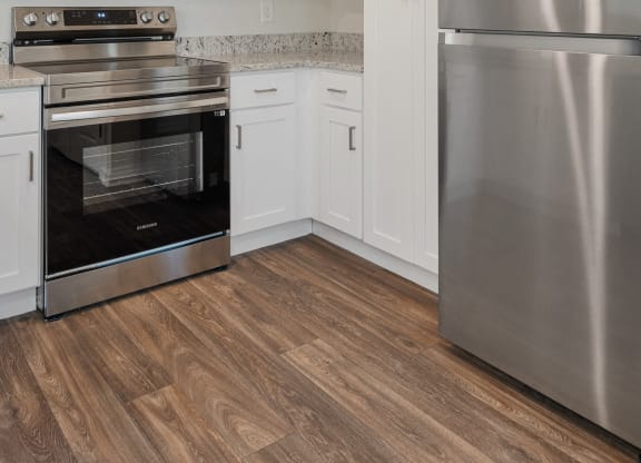 a kitchen with stainless steel appliances and white cabinets