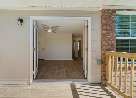 the view from the front porch of a house with a door open to a hallway