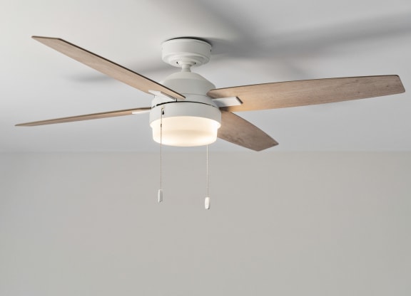 a ceiling fan with a light hanging from it
