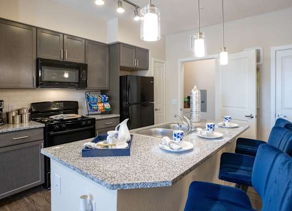 an open kitchen with granite counter tops and stainless steel appliances