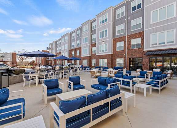 A patio area with blue and white furniture.