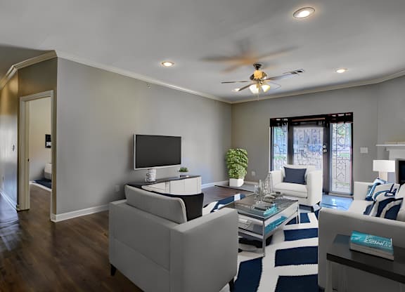 A modern living room with a white couch and a television.