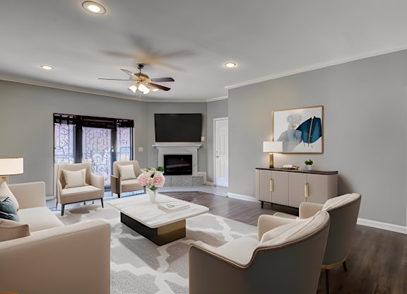 A living room with a fireplace and a painting on the wall.