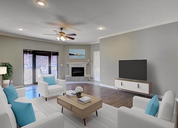 A living room with a fireplace and a television.
