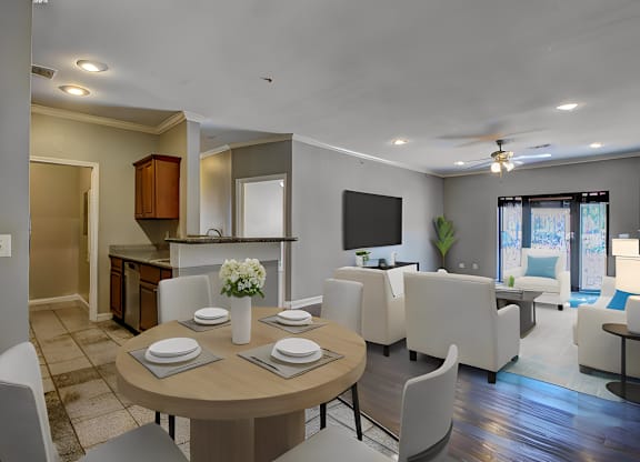 A modern dining room with a round table set for four.