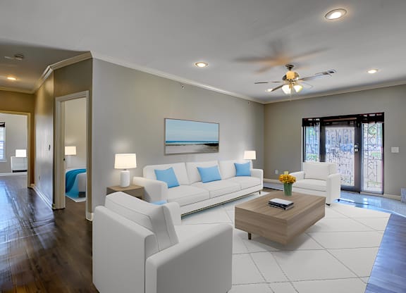 A modern living room with a white sofa set and a wooden coffee table.