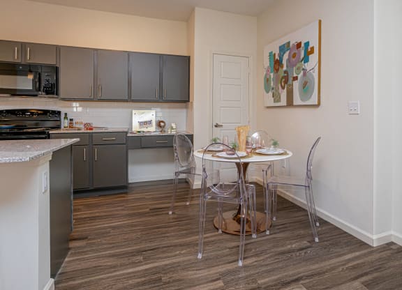 a kitchen and dining room with a small table and chairs