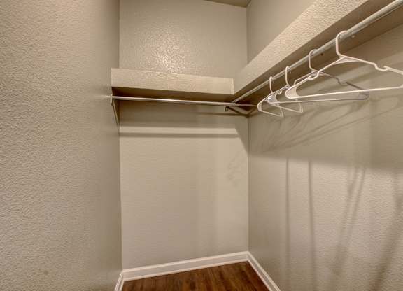 A white closet with a white hanger.
