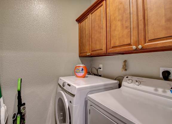 A small laundry room with a washer and dryer.