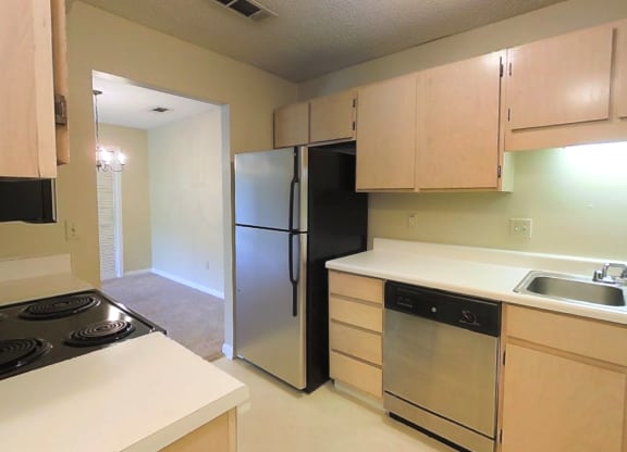 a kitchen with a stove and a refrigerator