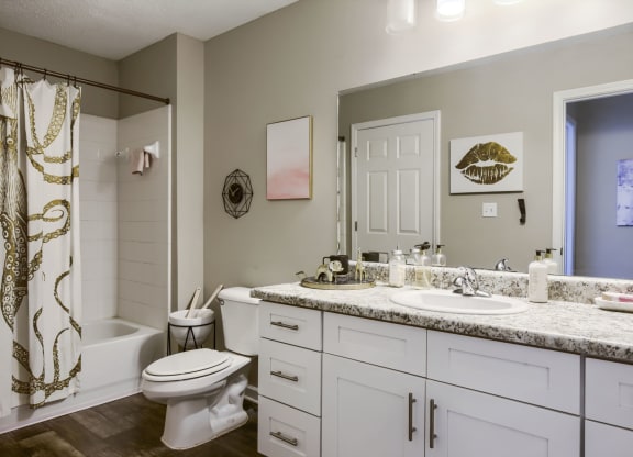 a bathroom with a white toilet next to a white sink