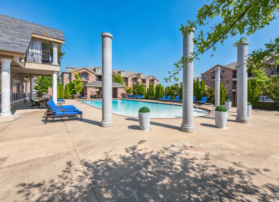 our apartments offer a swimming pool with lounge chairs and trees