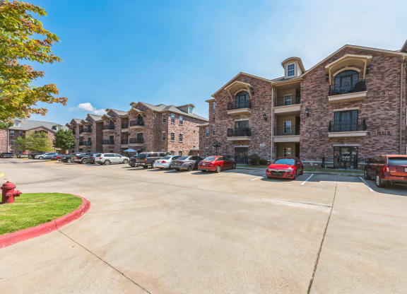 an empty parking lot in front of an apartment building