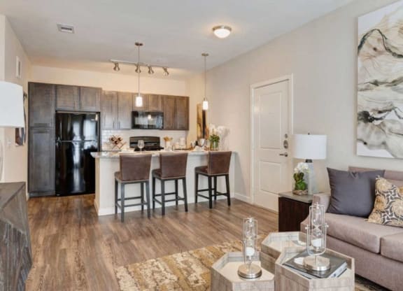a living room and kitchen with a couch and a table
