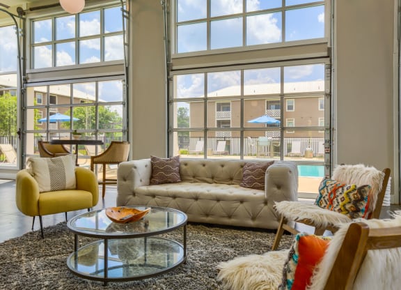 a living room filled with furniture and a large window