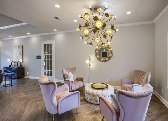 a living room filled with furniture and a large chandelier