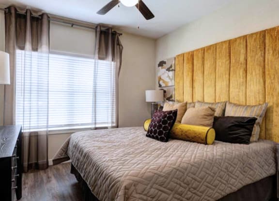 a bedroom with a large bed and a window