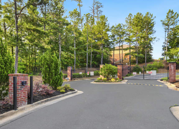 a large driveway with a brick fence and brick pillars