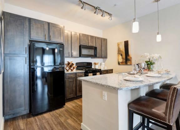 a kitchen with stainless steel appliances and a granite counter top