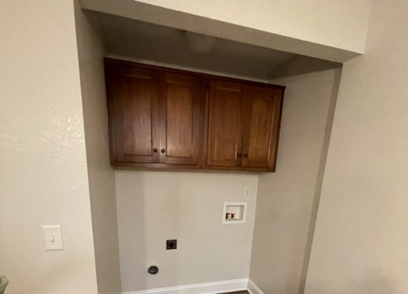 an empty room with a hardwood floor and white walls