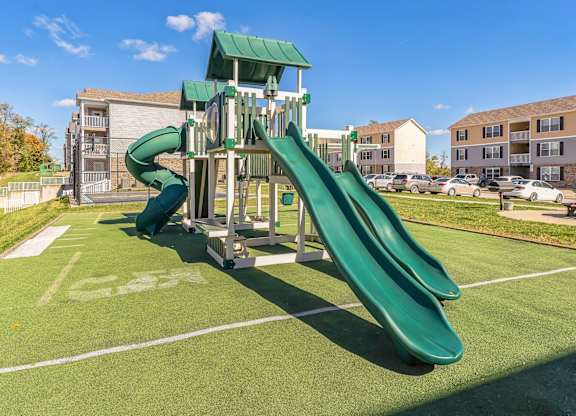 a playground with a slide in a park