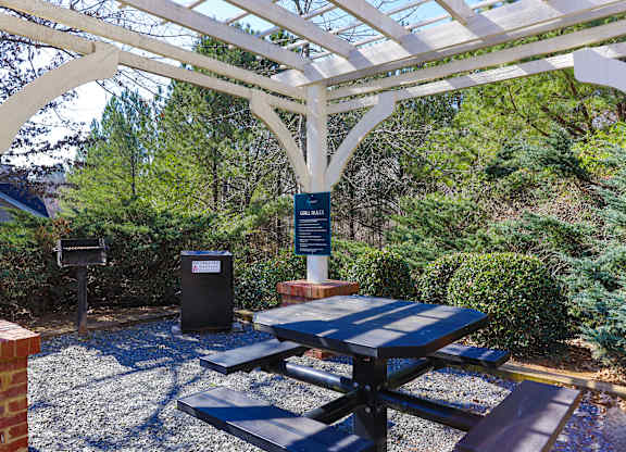 a picnic area with a table and benches