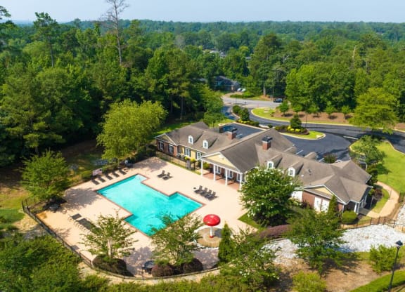 a aerial view of a house with a swimming pool and a mansion