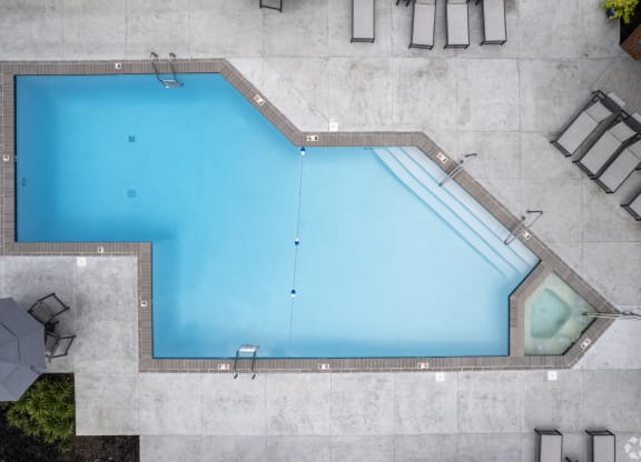 an aerial view of a swimming pool with blue water