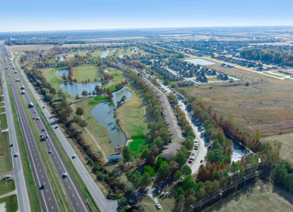 an aerial view of a wetland area next to a highway