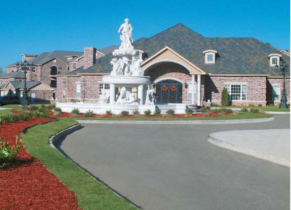 A house with a statue in front of it.