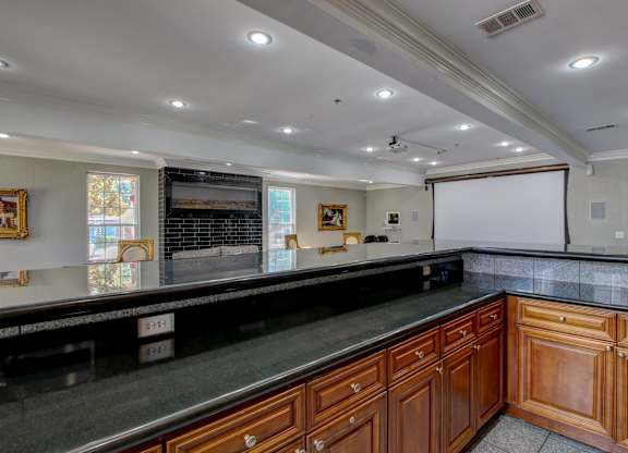 A kitchen with wooden cabinets and a black countertop.
