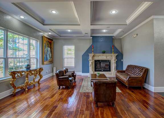 A living room with a fireplace and a painting on the wall.