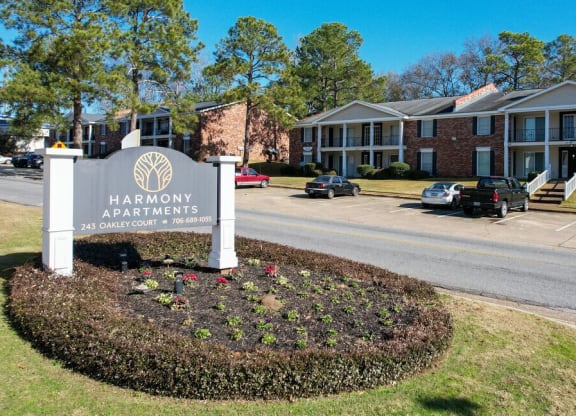a sign apartments in front of a street