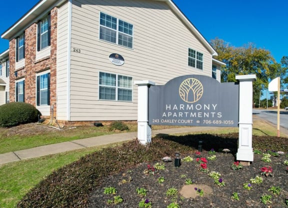 the apartments entrance sign in front of the building