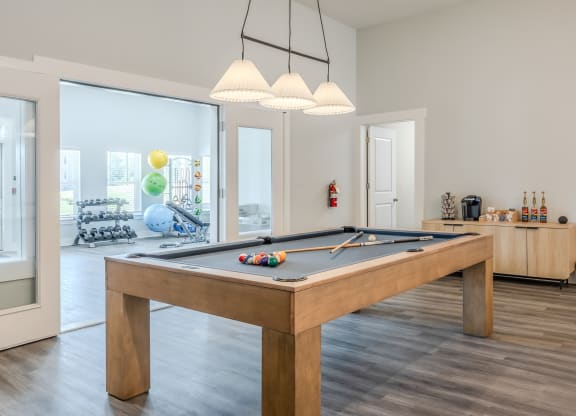 a games room with a pool table in a house